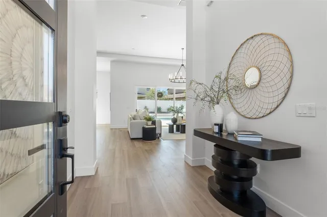 a living room with furniture a chandelier and a flat screen tv