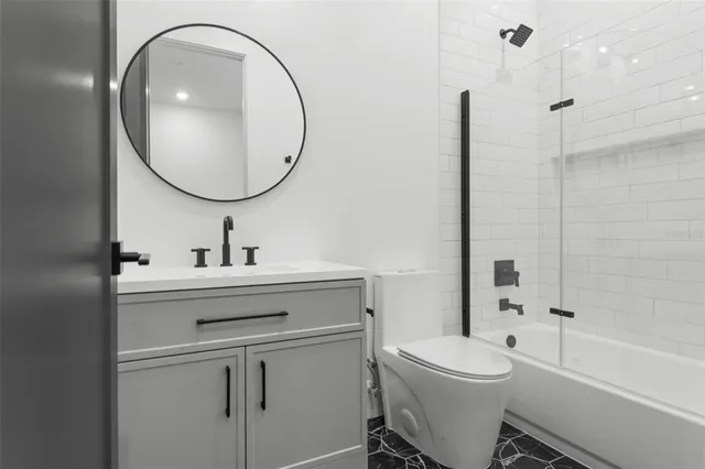 a view of an house with a yard and a car park