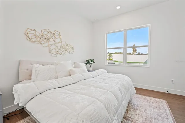 an aerial view of a house with a yard and lake