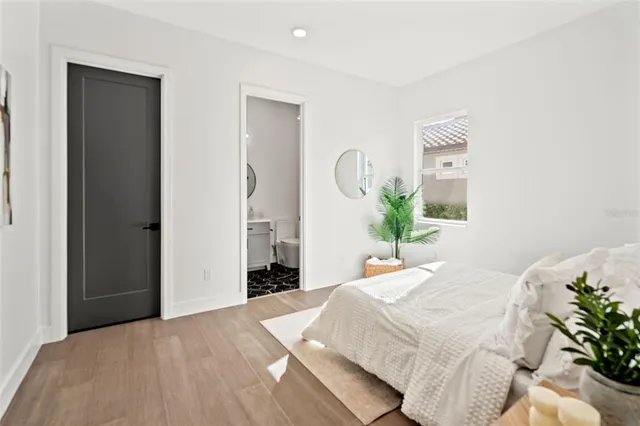 a dining room with furniture a rug a flat screen tv and a clock