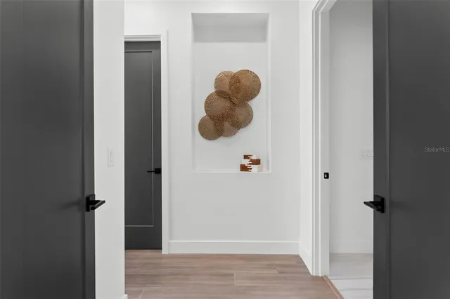 a bedroom with a bed and a painting on the wall