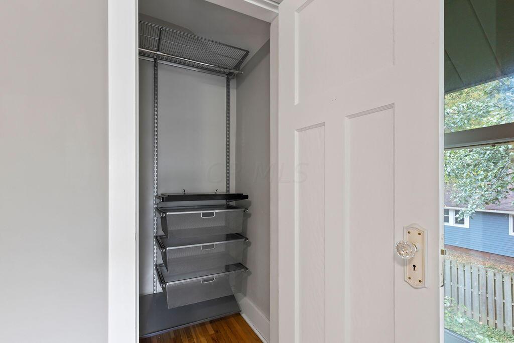 222 Brighton Road Columbus, OH 43202 - Photo 28 of 46 • Re-finished hardwood flooring 2023 • Lighted ceiling fan • Light grey painted walls • Closet storage organizers