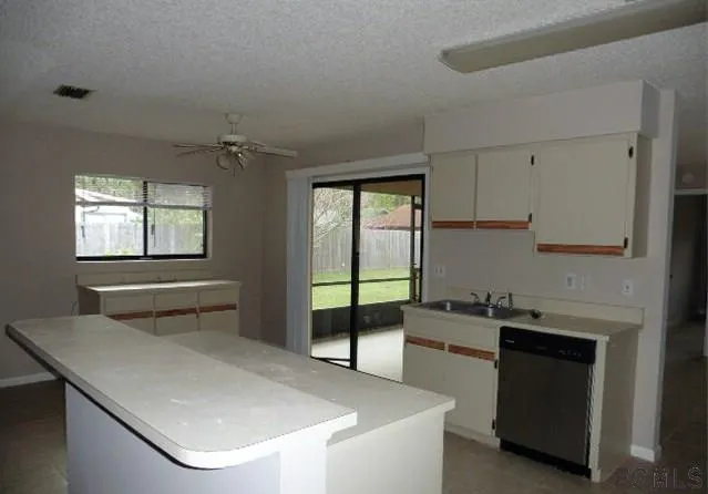 a kitchen with a sink a stove and cabinets