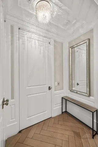 a view of a balcony with chairs and a potted plant