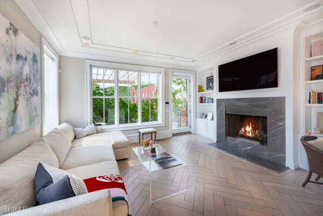 a living room with furniture a flat screen tv and a fireplace