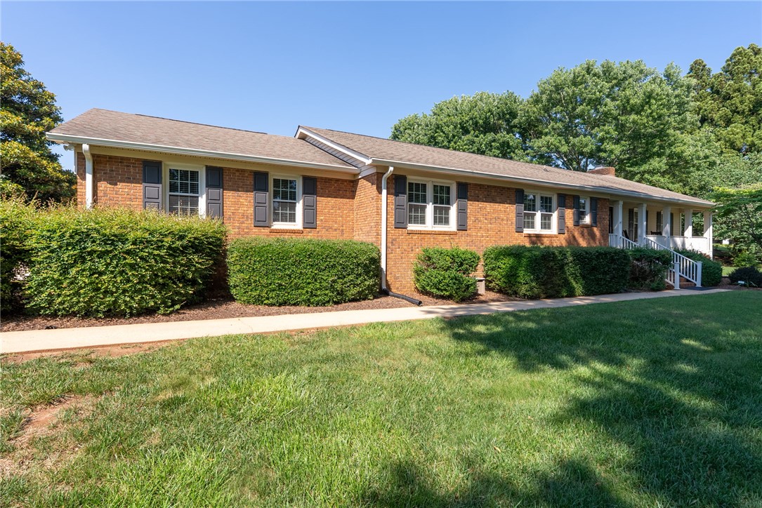 3513 Hopewell Road Anderson, SC 29621 - Photo 45 of 50 A classic brick exterior, framed by vibrant green shrubs, offers welcoming curb appeal.