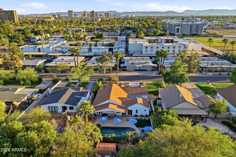an aerial view of a house with a swimming pool yard and outdoor seating