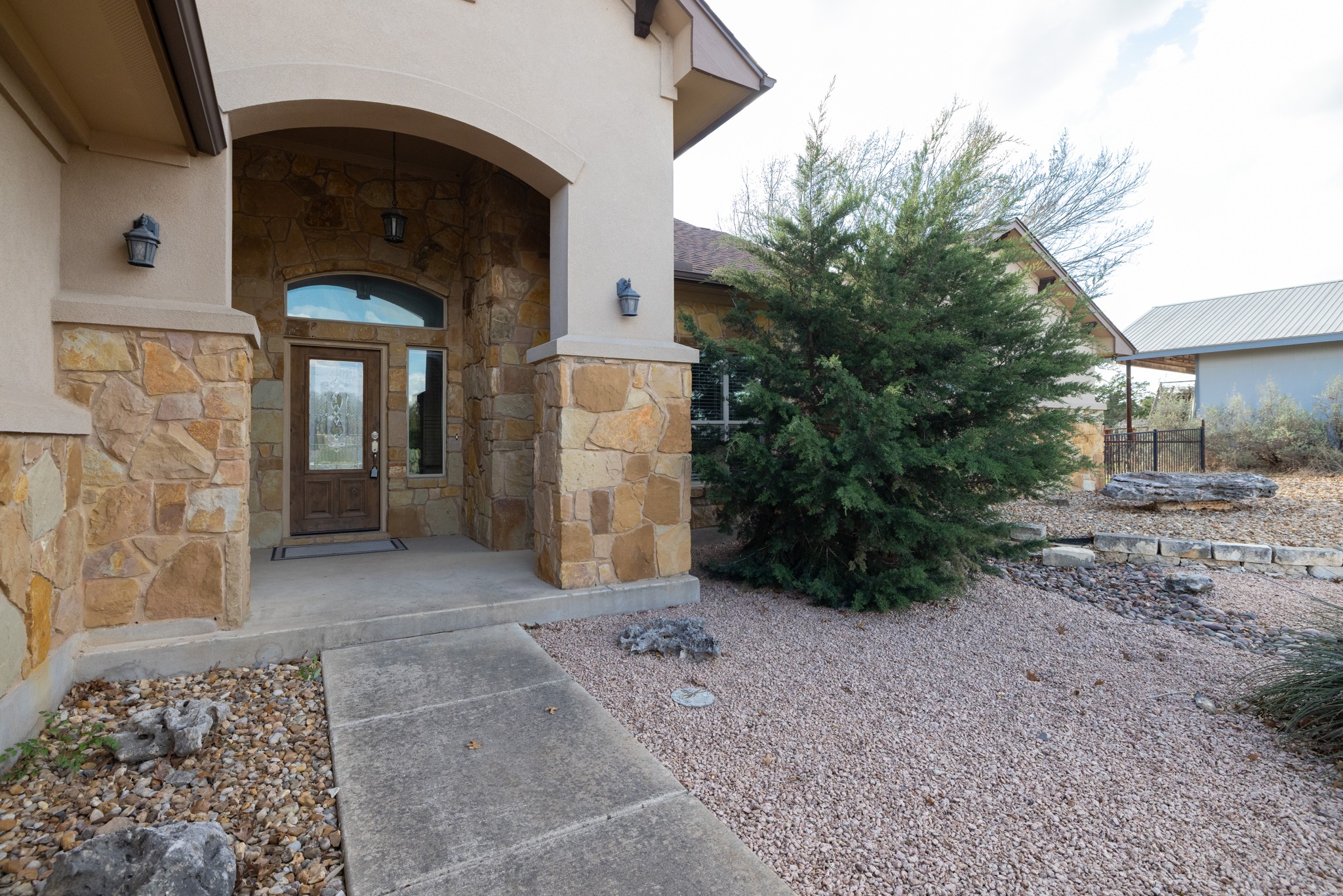 204 Skyline Road Georgetown, TX 78628 - Photo 10 of 40 View of exterior entry featuring stone siding, covered porch, and stucco siding
