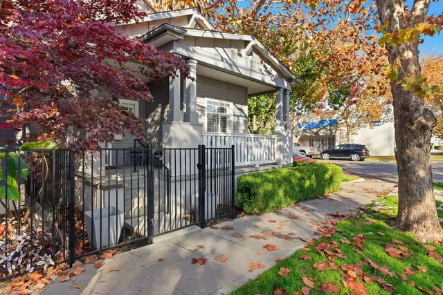 a view of a house with a small yard and plants