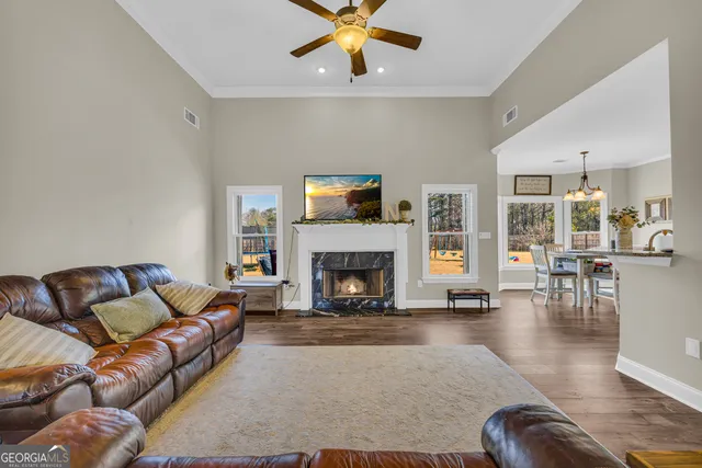 a living room with furniture and kitchen view