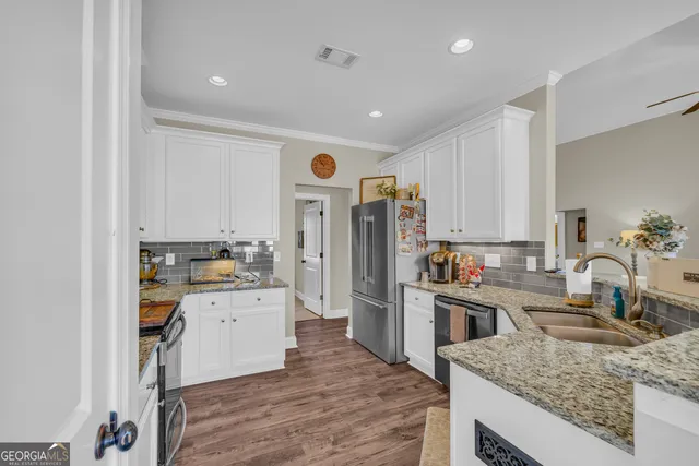 a kitchen with a sink stove top oven and refrigerator