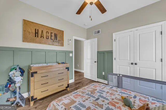 a bedroom with a large bed and a large mirror