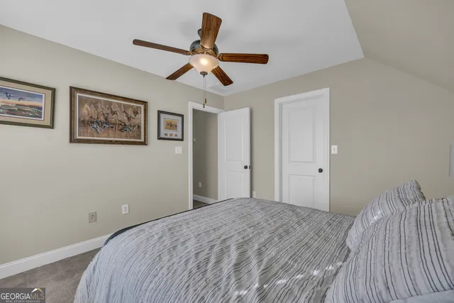 an aerial view of ocean and residential houses with outdoor space