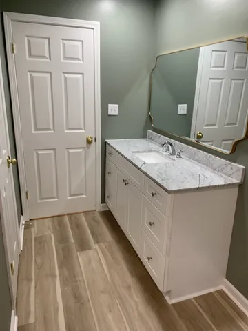 a view of a room with a ceiling fan and a window