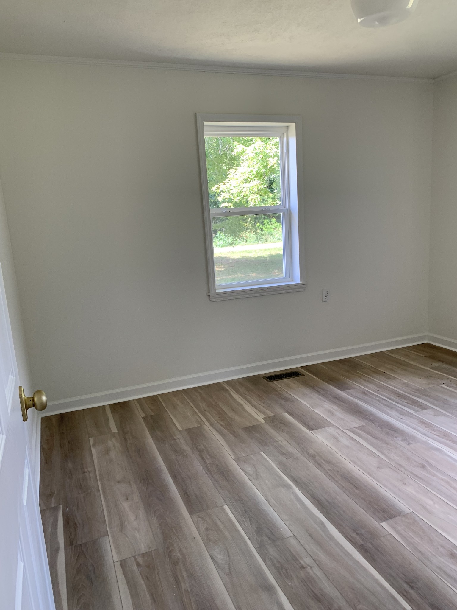5870 Chestnut Bluff Road Friendship, TN 38034 - Photo 19 of 19 an empty room with wooden floor and windows