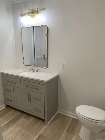 a bathroom with a toilet sink and mirror