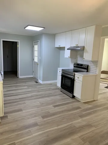 a kitchen with granite countertop a stove and a sink