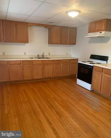 a kitchen with granite countertop a stove and a sink