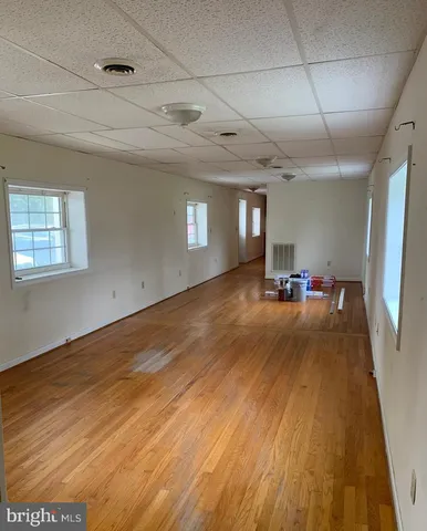 a view of a room with gym equipment and windows