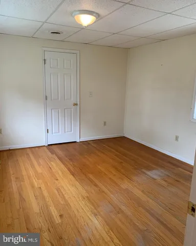 an empty room with wooden floor