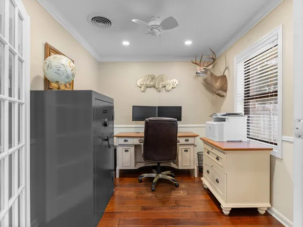 a view of a workspace with furniture and a window