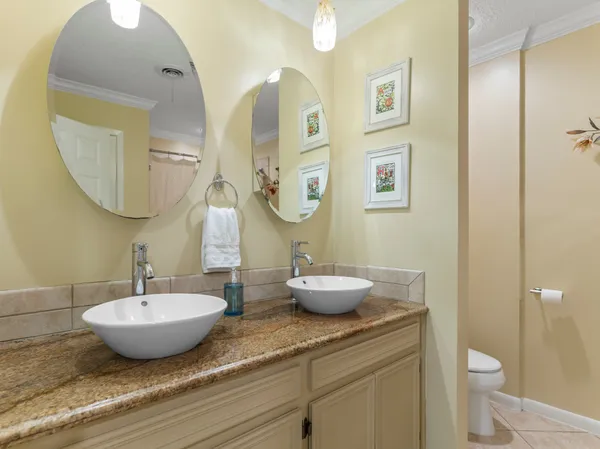 a bedroom with a white bed and a chandelier