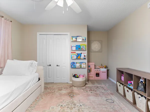 a spacious bedroom with a bed and a chandelier