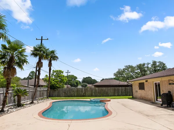a view of a house with swimming pool and porch