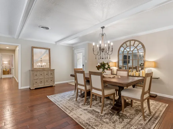 a view of a a dining room with furniture window and wooden floor