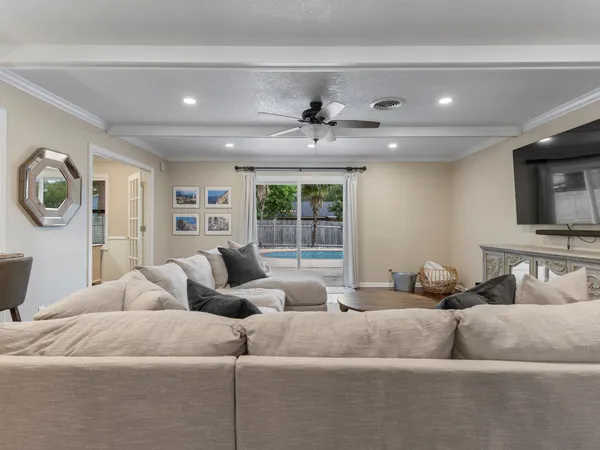 a living room with couches and a flat screen tv