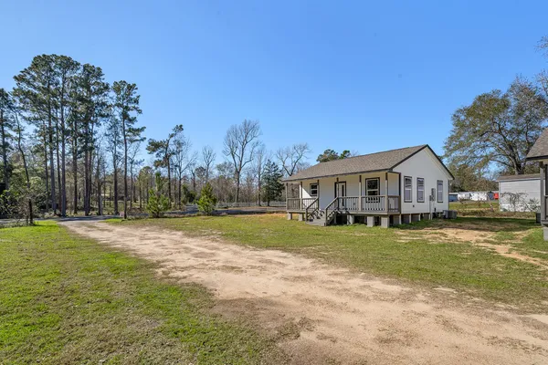 a front view of house with yard and green space
