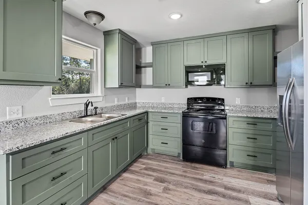 a kitchen with a refrigerator stove and sink
