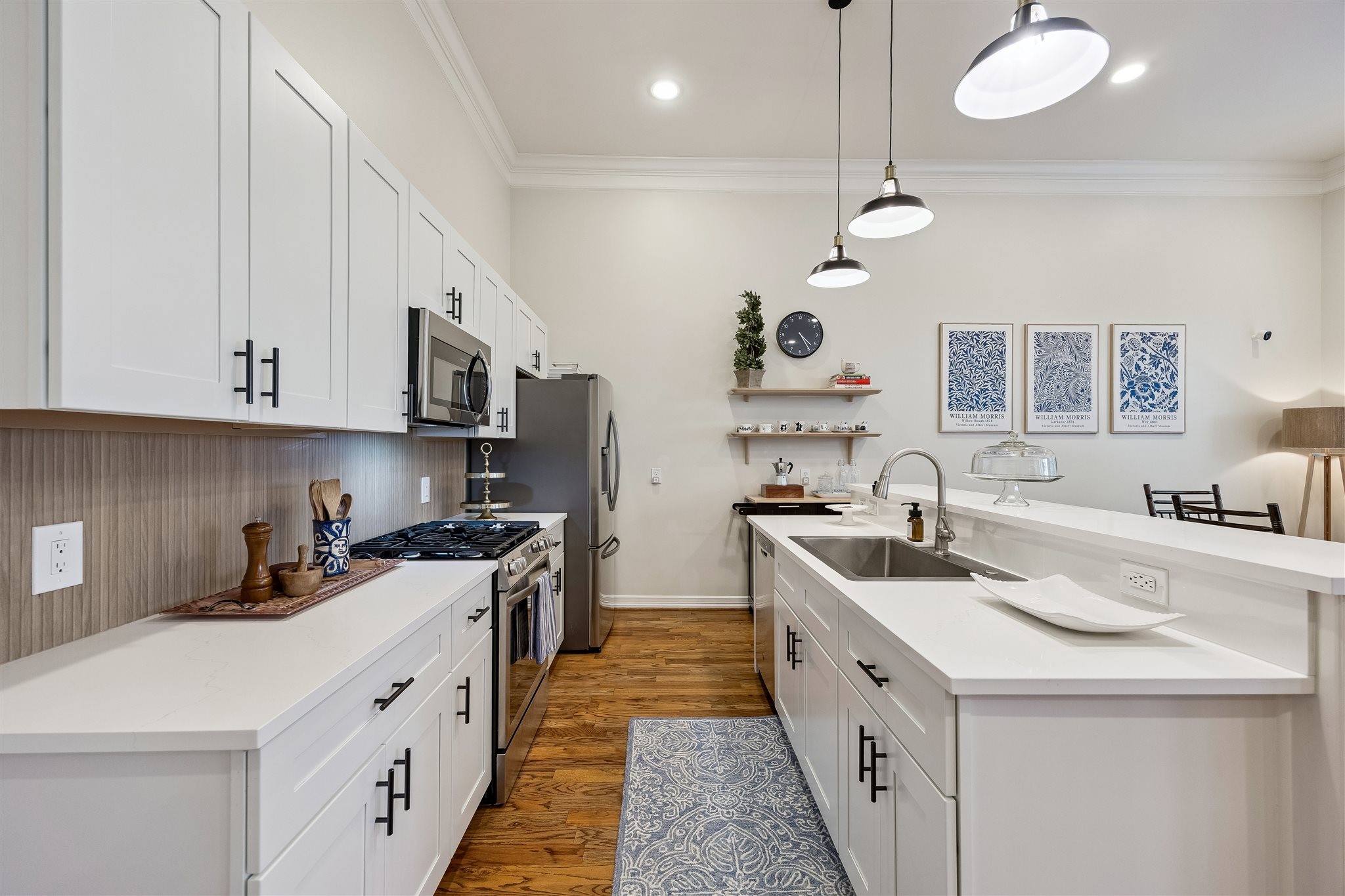 1514 Campbell Road, Unit B Houston, TX 77055 - Photo 11 of 31 Close up view of the renovated kitchen featuring plywood construction slow close cabinets 2025, quartz counters 2025, kitchen sink and faucet 2025, gas range and microwave/vent hood 2025.