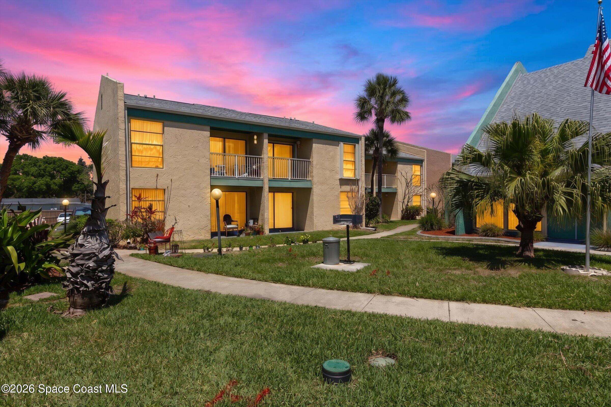 1225 North Wickham Road, Unit 223 Melbourne, FL 32935 - Photo 15 of 26 a front view of a house with a garden