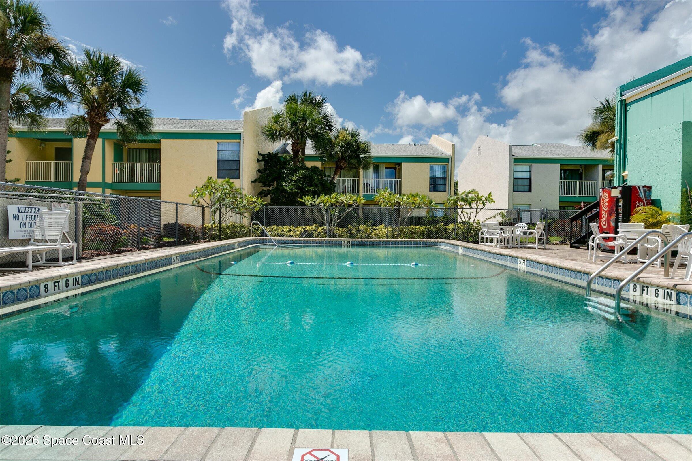 1225 North Wickham Road, Unit 223 Melbourne, FL 32935 - Photo 16 of 26 a swimming pool view with a outdoor seating