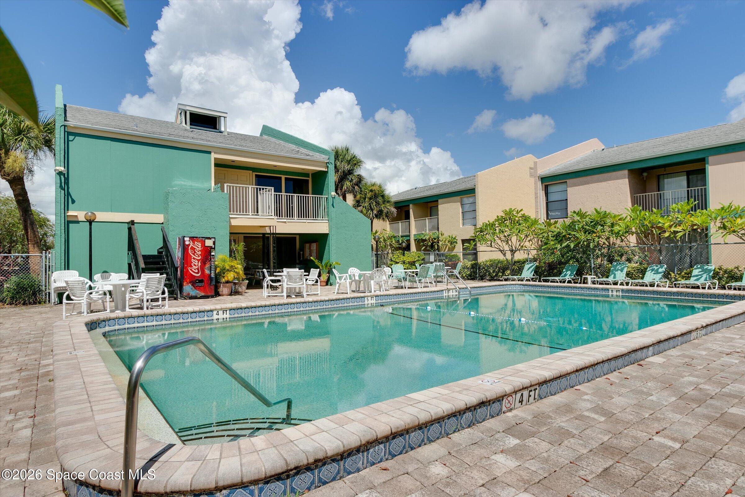 1225 North Wickham Road, Unit 223 Melbourne, FL 32935 - Photo 17 of 26 a view of house with swimming pool and furniture