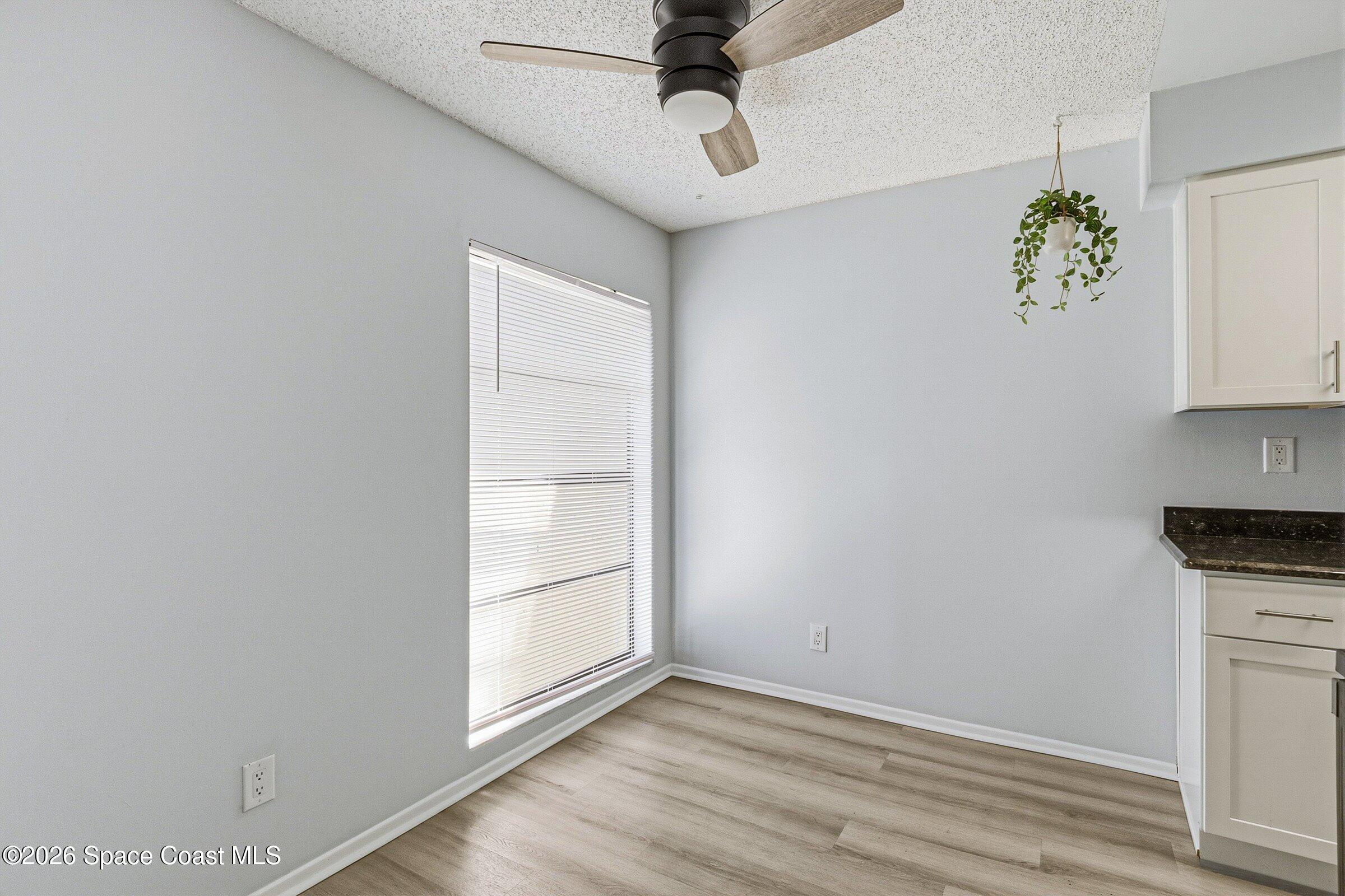 1225 North Wickham Road, Unit 223 Melbourne, FL 32935 - Photo 7 of 26 a view of cabinets and wooden floor