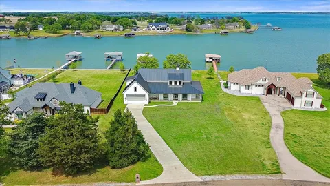 an aerial view of a house with a lake view