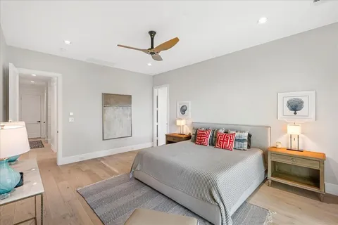 a bedroom with a bed and a chandelier