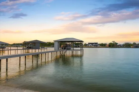 a view of a lake with houses in the back