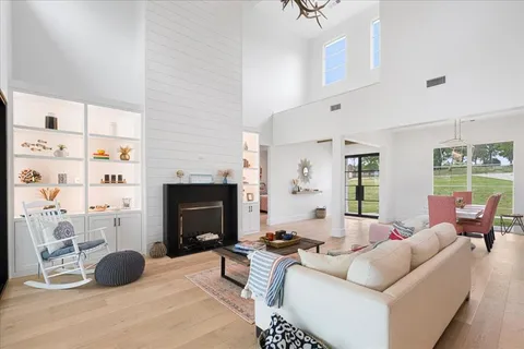 a living room with furniture a fireplace and a window