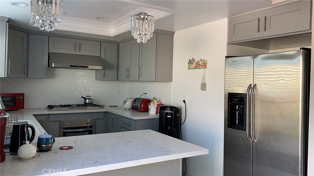 509 West Duarte Road, Unit B Monrovia, CA 91016 - Photo 5 of 20 a kitchen with stainless steel appliances a refrigerator a sink a stove and cabinets