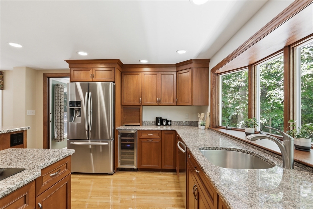 2 Olde Lyme Road Winchester, MA 01890 - Photo 11 of 42 a kitchen with stainless steel appliances granite countertop a refrigerator a sink a stove a washer dryer and a counter space