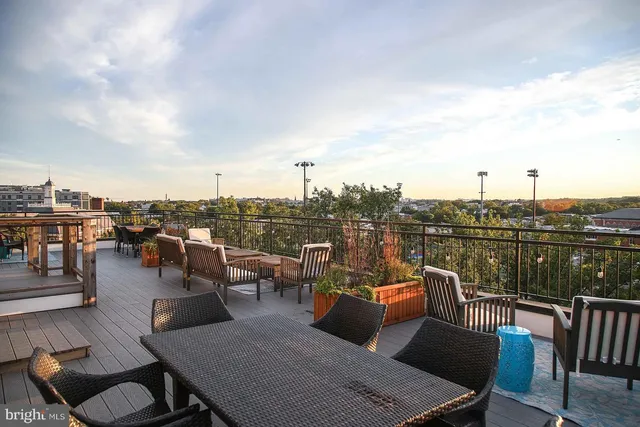 a view of a balcony with wooden floor and lake view