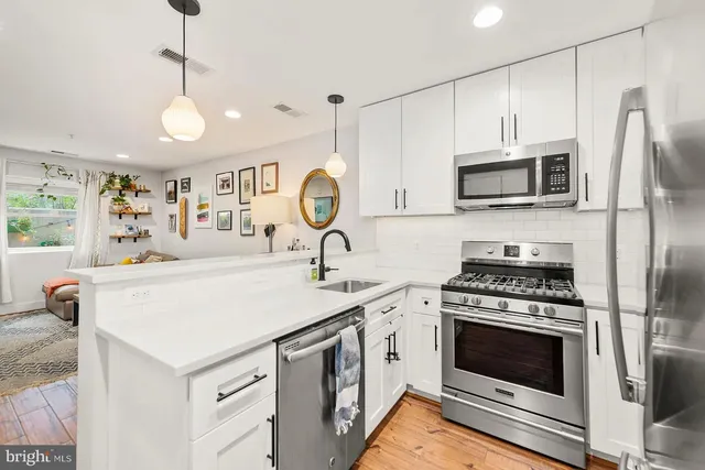 a kitchen with a stove a microwave and a refrigerator