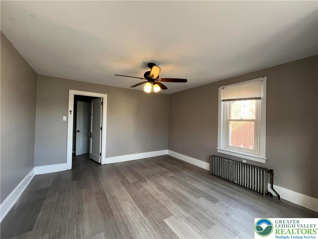 2402-2404 South 4th Street Allentown, PA 18103 - Photo 12 of 21 a view of empty room with wooden floor and fan