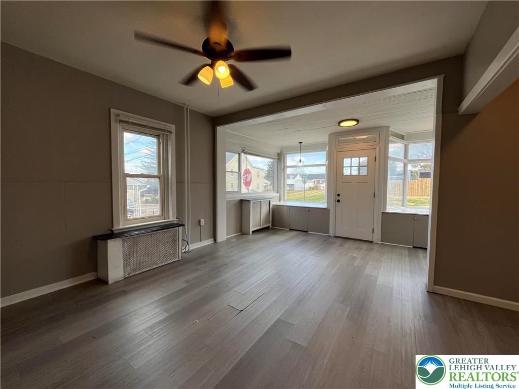 2402-2404 South 4th Street Allentown, PA 18103 - Photo 4 of 21 an empty room with wooden floor and windows