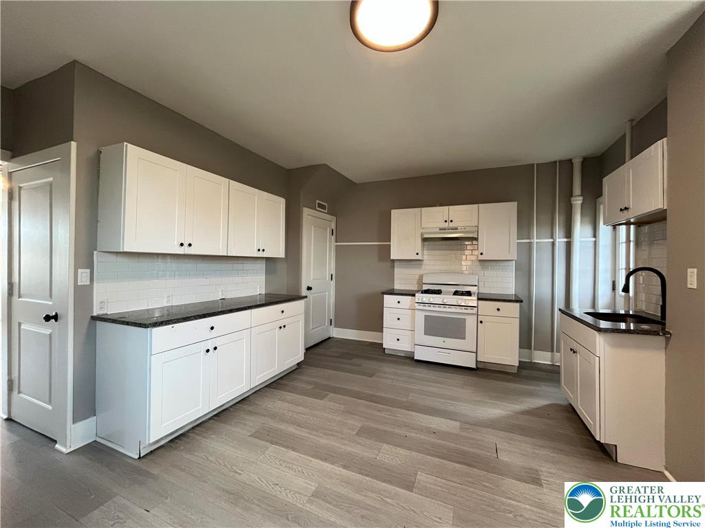 2402-2404 South 4th Street Allentown, PA 18103 - Photo 6 of 21 a kitchen with stainless steel appliances a stove a sink and a refrigerator