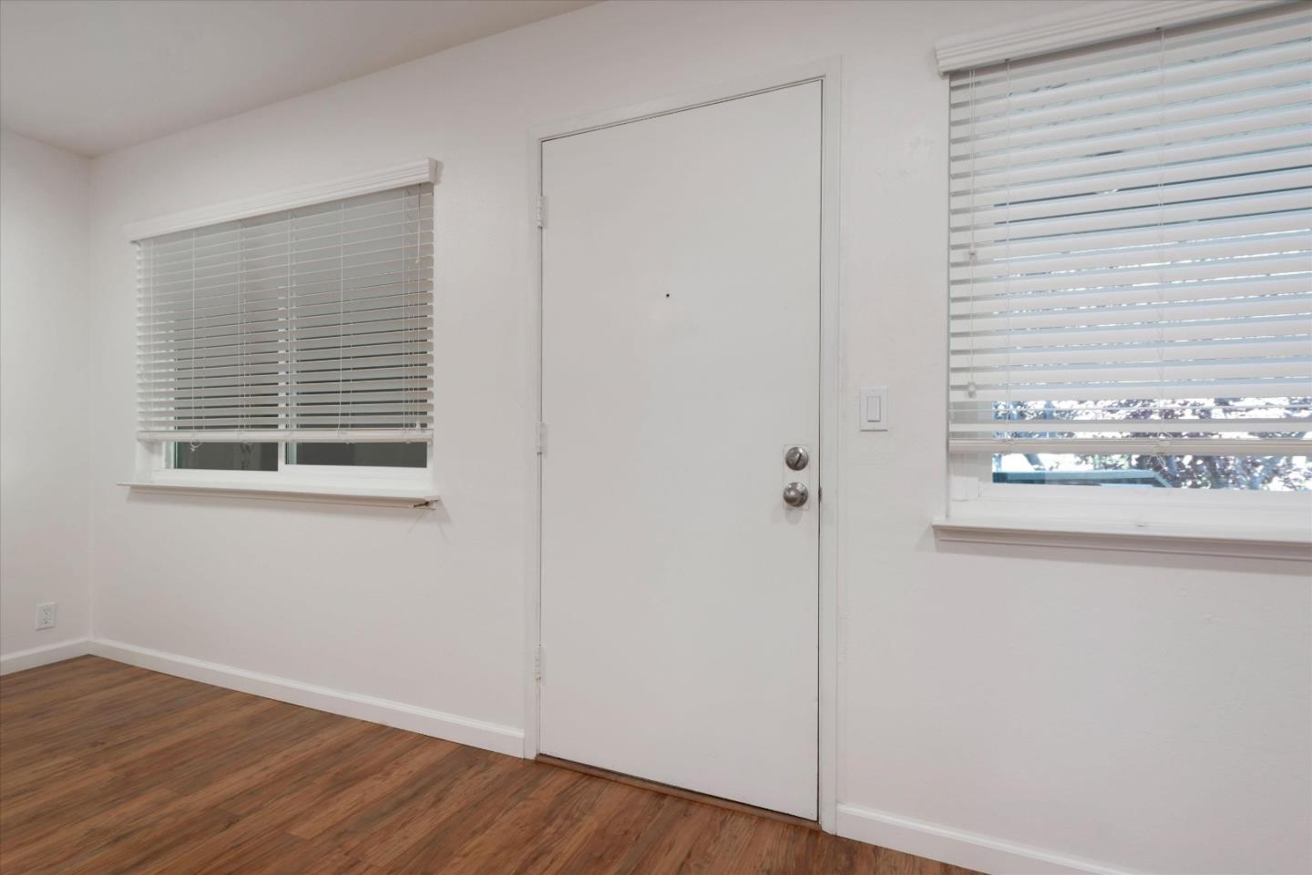 2025 California Street, Unit 42 Mountain View, CA 94040 - Photo 5 of 16 a view of an empty room with wooden floor and a window