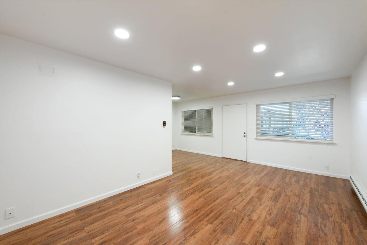 2025 California Street, Unit 42 Mountain View, CA 94040 - Photo 6 of 16 a view of an empty room with wooden floor and a window